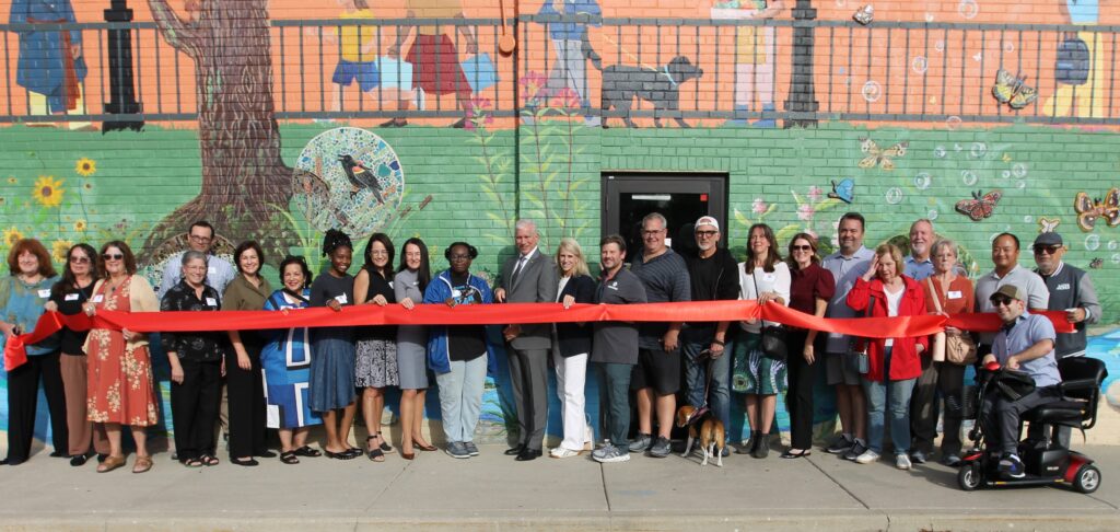 Project team members stand in front of the new Downtown Glenview mural during the ribbon cutting ceremony.